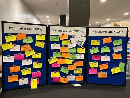 A wellness board covered in handwritten notes about happiness and gratitude